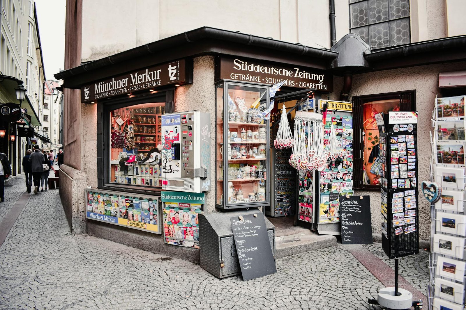 Explore the charm of Munich with this street-side kiosk in the historic Old Town, offering souvenirs and local delights.